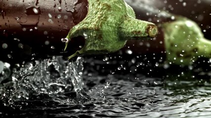 Super slow motion Fresh eggplant with splashes and drops of water . Filmed on a high-speed camera at 1000 fps. High quality FullHD footage - Powered by Adobe