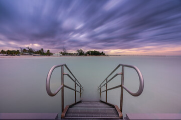 Long exposure of stairs leading towards a bay of water in Key West Florida 