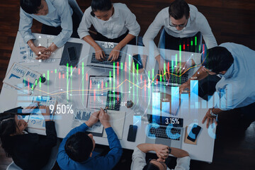 A diverse group of business professionals engages in collaborative financial analysis, utilizing laptops and displaying charts in a modern office environment. Scalp