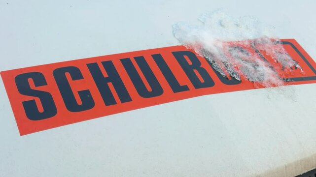Close up of German School Bus Sign &ldquo;Schulbus&rdquo; Covered with Snow and Ice