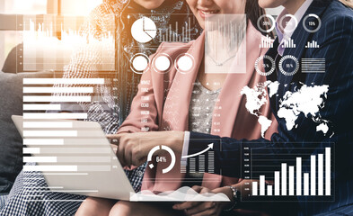 A group of professionals collaborates in a modern office setting, analyzing data and discussing business strategies using graphs and charts displayed on a laptop. Impute