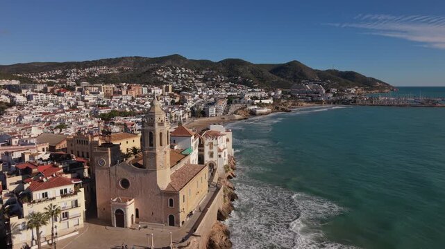 flying past church towards beach in Sitges Spain