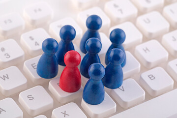 Unique person in the crowd on computer keyboard