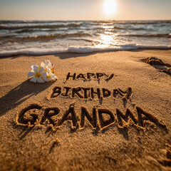 Happy Birthday Grandma Casual Beach Message in Wet Sand with White Jasmine Accent, Warm Sunset Sun Disc and Clean Foam Lines &ndash; great for greeting cards