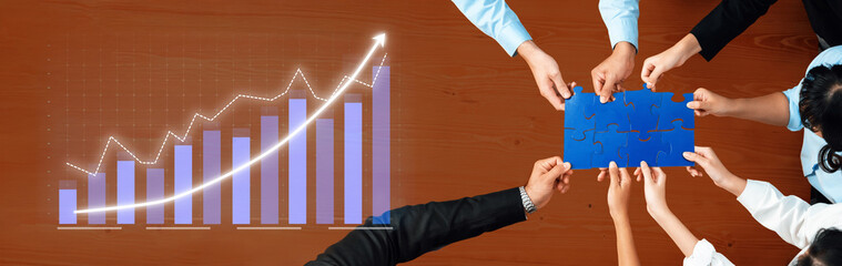 Team members collaborate effectively at a modern workspace, analyzing data on growth metrics while...