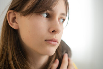 School-age girl carefully handling her pet gray rat. Demonstration of proper rodent care and meaningful pet relationship.