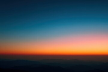Obraz premium Vibrant Gradient Sky at Dusk with Mountain Silhouette in Dark Blue Orange and Pink Hues Creating a Peaceful Atmospheric Landscape Optimized for Stock