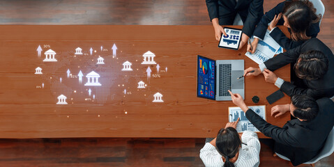 Diverse business team engaged in strategic planning, utilizing data analytics on digital platforms to drive financial growth and enhance collaboration in a modern workspace. Trope