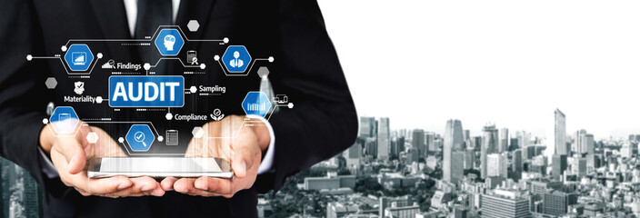 A professional holding a digital interface displaying audit-related symbols over a city skyline, symbolizing financial analysis and compliance in business. Tessel