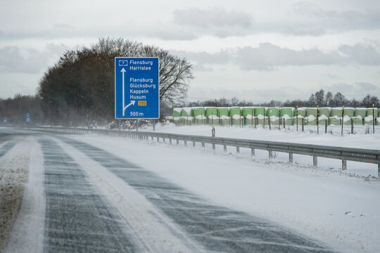 Snow covered A7 E45 exit near Flensburg during winter storm Elli Goretti January 2026