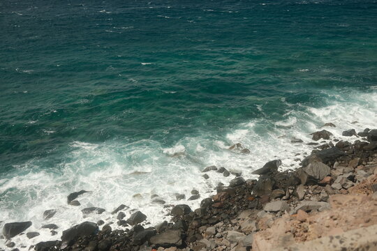 Powerful Ocean Waves Crashing Over Coastal Rocks on a Windy Day, Horiztontal Image With Copy Space.