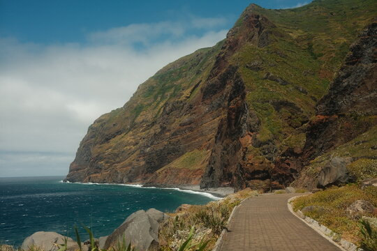 Scenic Cliffside Walkway Curving Along Rugged Coast with Breathtaking Ocean Backdrop