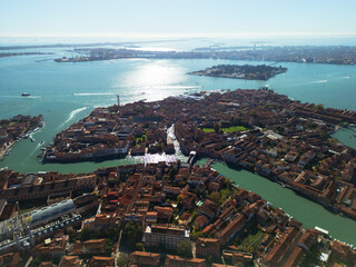 High altitude aerial view of Murano island with orange rooftops and canals, scenic panorama of...