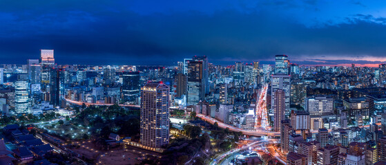 Panoramic view of Tokyo Minato-ku area with busy Akabanebashi intersection at blue hour