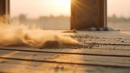 Cinematic shot of dust motes floating in the air on a wooden floor at sunrise with warm light