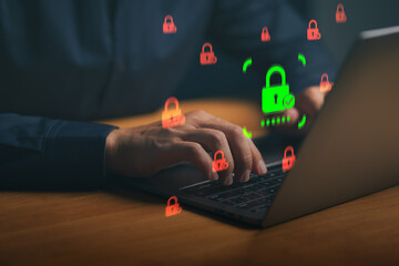 Close-up of hands typing on laptop with virtual security padlock icons. Cybersecurity concept for data protection, network safety, and hacking prevention.