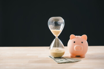 Time money hourglass and piggy bank demonstrate finance concept, illustrating prudent saving investment, growing wealth, and smart purchase stock market strategy for future