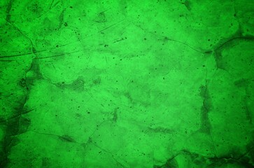 Vivid, textured green surface with pronounced cracks creates a bold abstract backdrop. Ideal for nature-inspired, eco-friendly, or modern design projects needing a striking green texture.