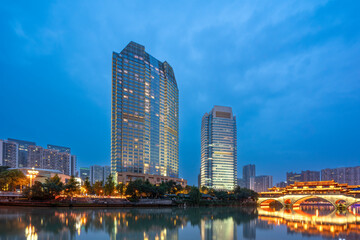 Fototapeta premium Modern Skyscrapers by River at Dusk