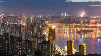 Fototapeta premium Night View of Chongqing Cityscape with Illuminated Skyscrapers
