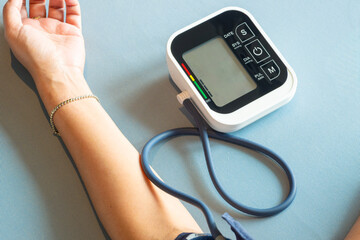 Man check blood pressure monitor and heart rate monitor with digital pressure gauge. Health care and Medical concept	