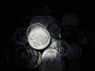 Stack of silver coins in dark low key.