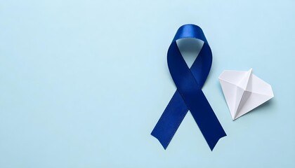 Blue ribbon and hand with a stop sign on a white background, symbolizing awareness for National Child Abuse Prevention Month
