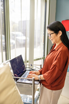 Female doctor typing on the laptop for documentation