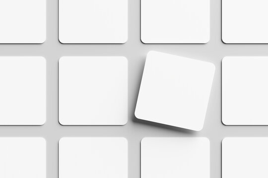 Blank white square business card mockup, placed on a gray background. Flat lay, top view, open composition.