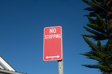 no stopping sign against blue sky