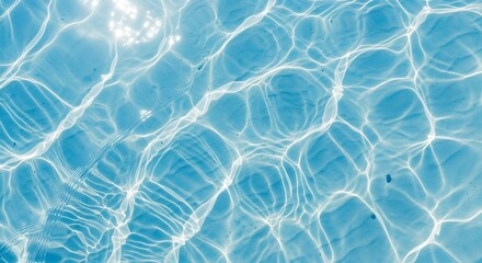 Rippled sunlight dances across calm clear pool water surface