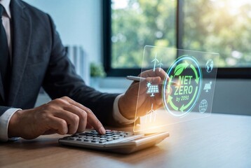 Businessman using calculator for net zero carbon neutrality goals with virtual sustainability screen