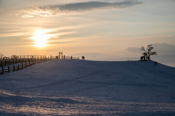 Silhouette of tourist while visiting Cape Burkhan during sunset on Olkhon Island in Lake Baikal, Russia.