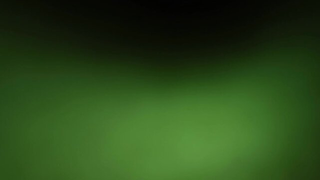 Una toma de cerca de un fondo abstracto de color verde con negro un degradado ligero desenfocado en movimiento