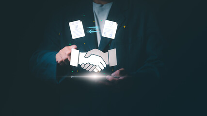 Businessman using smartphone with handshake and digital contract icons, Concept of business partnership, electronic signature, smart contract, successful deal, and online legal agreement.