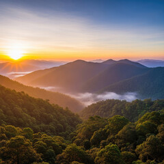 Sunrise Over Lush Green Mountain Range with Foggy Valleys.