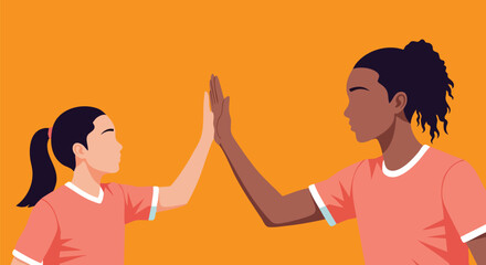 Two women giving each other a high-five in a vibrant orange setting