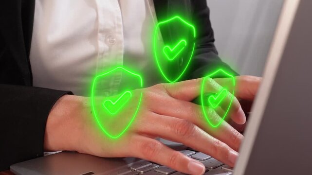 Businesswoman working on computer shield icons with check mark
