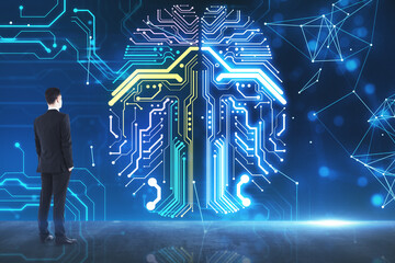 Businessman observing giant glowing digital brain made of electronic circuits, representing artificial intelligence innovation, neural networks, machine learning and futuristic data technology

