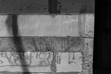 Exposed lightweight brick wall integrated with concrete bond beams