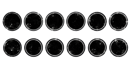 Twelve distressed grunge black circular shapes mimicking worn rubber stamps/wax seals with rough edges, speckles, ink bleed, some with white rings, arranged on a bright white background, clean studio