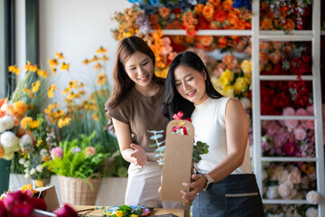 Florist helping customer choosing flower bouquet in shop
