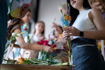 Florist teaching flower arranging skill in workshop