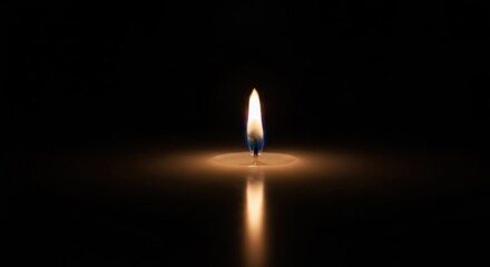 Single candle flame glowing on dark background, reflecting light