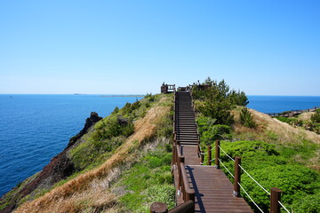 fine walkway at seaside cliff and far islands