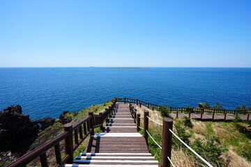 fine walkway at seaside cliff and far islands