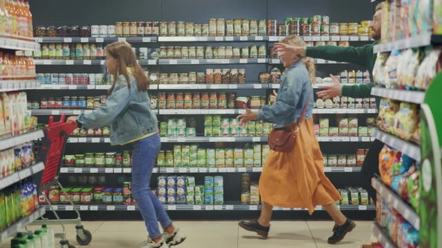 Energetic family engaging in spontaneous shopping fun among colorful grocery displays and bright lighting