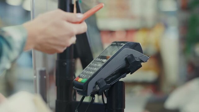 Customer easily pays contactlessly now, Busy store customer completes seamless contactless payment process