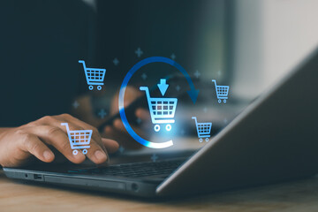 Online shopping concept with digital shopping cart icons on laptop screen, ecommerce technology add to cart process, digital payment system, retail business and customer purchase experience.