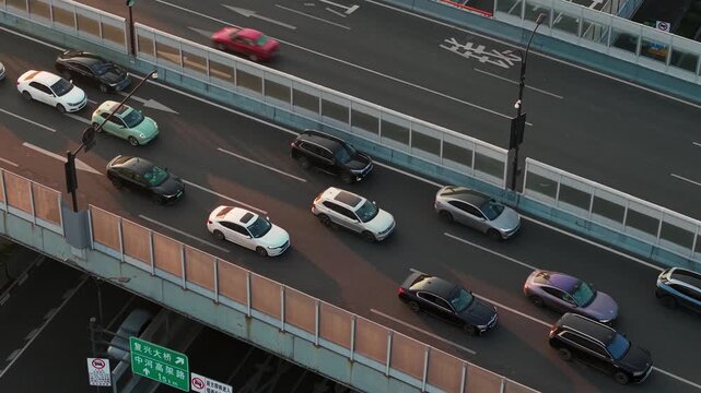 Aerial view of multilevel highway interchange with car and bus traffic in China during the sunset